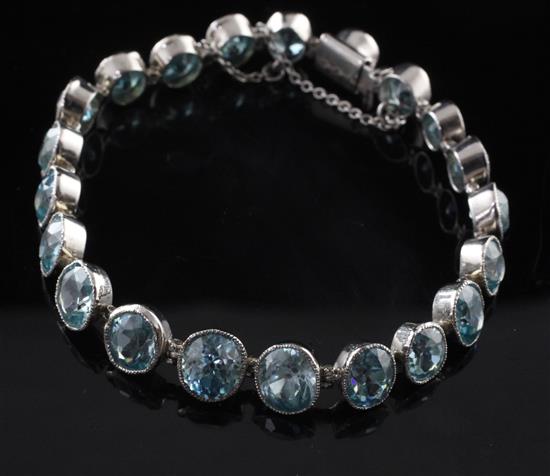 A white gold and blue zircon line bracelet, approx. 7in.